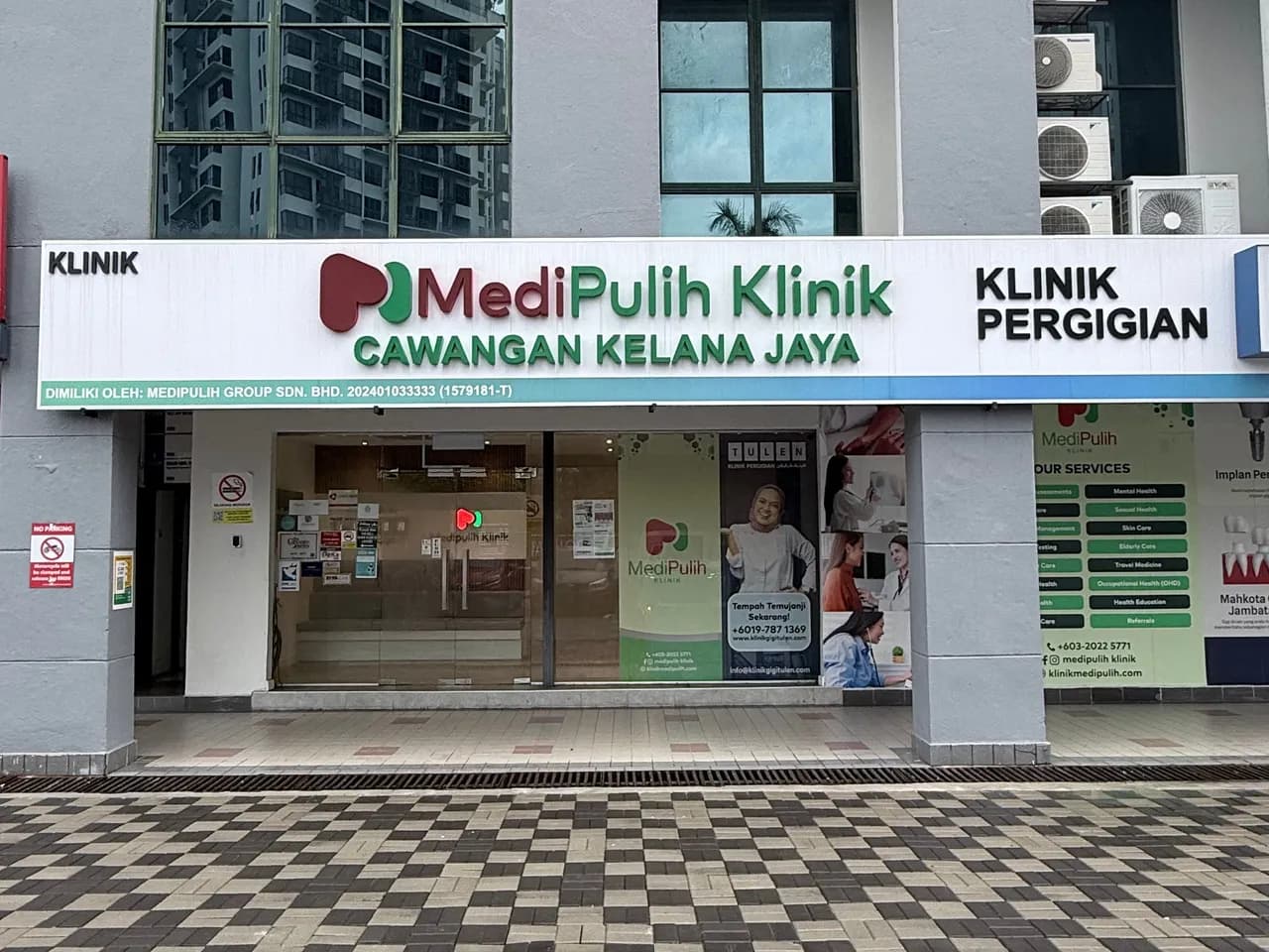The shopfront of MediPulih Klinik's Kelana Jaya branch, its sign reading MediPulih Klinik Cawangan Kelana Jaya above glass doors and posters listing the clinic's services.